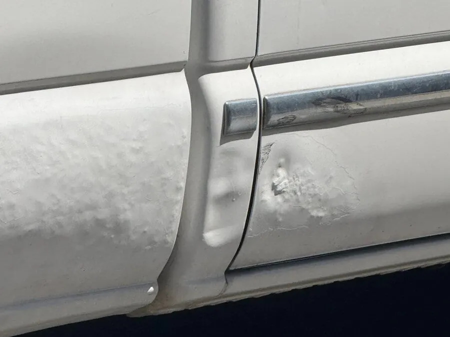 Vehicle panel with parking lot mobile PDR filler failing and lifting the factory paint