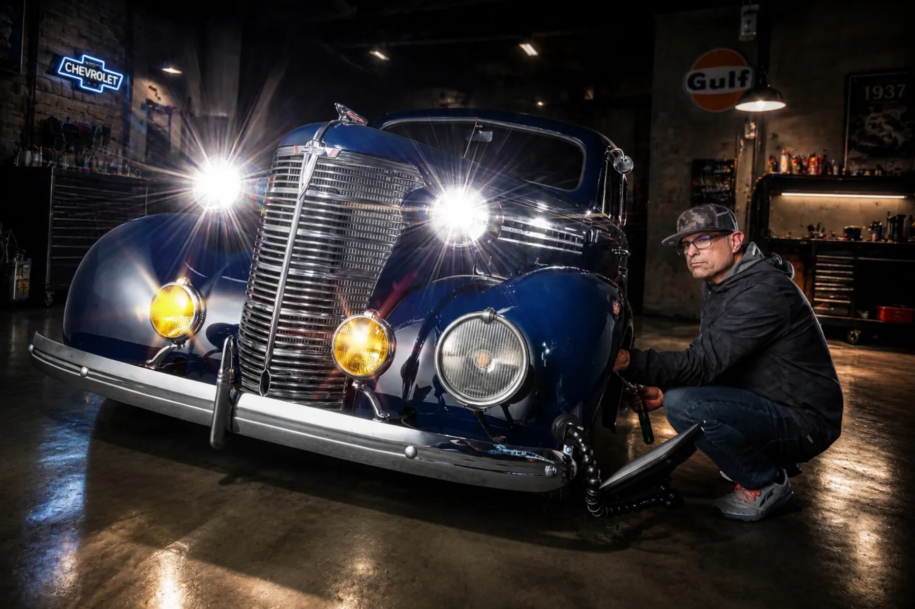 Myke Toledo working on a classic Chevrolet, original parts kept original
