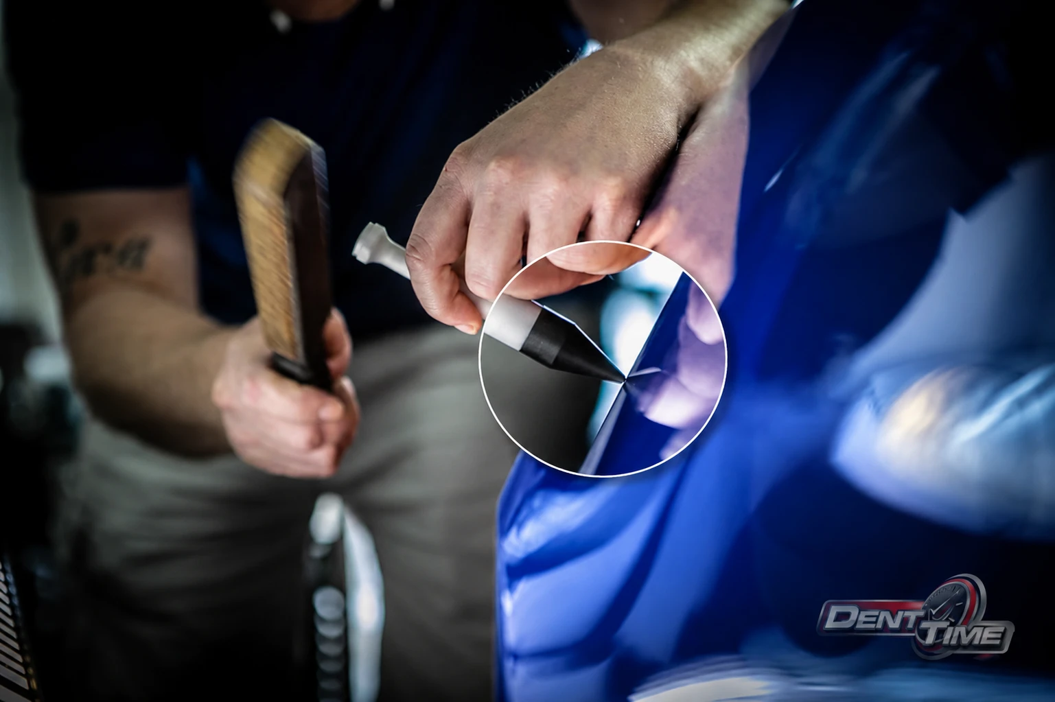 Tap-down tool placed on a sharp dent, magnified close-up from Dent Trainer online PDR training