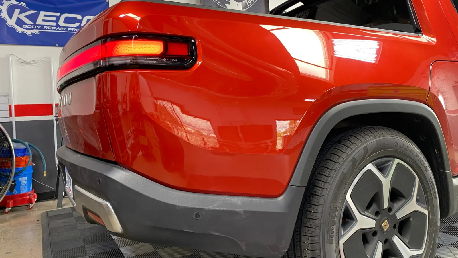Dent in Rivian panel before paintless dent repair in Laguna Niguel