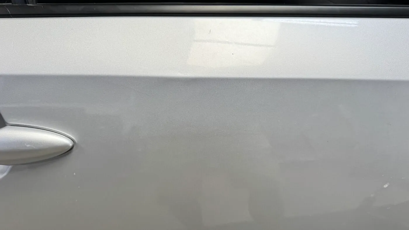 Silver door panel after a Practical standard paintless dent repair