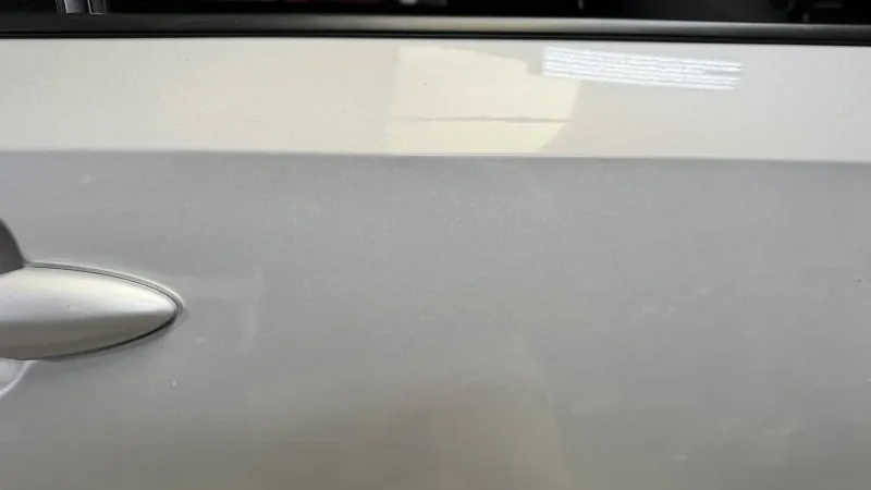 The same silver door after the dent was removed, factory paint kept