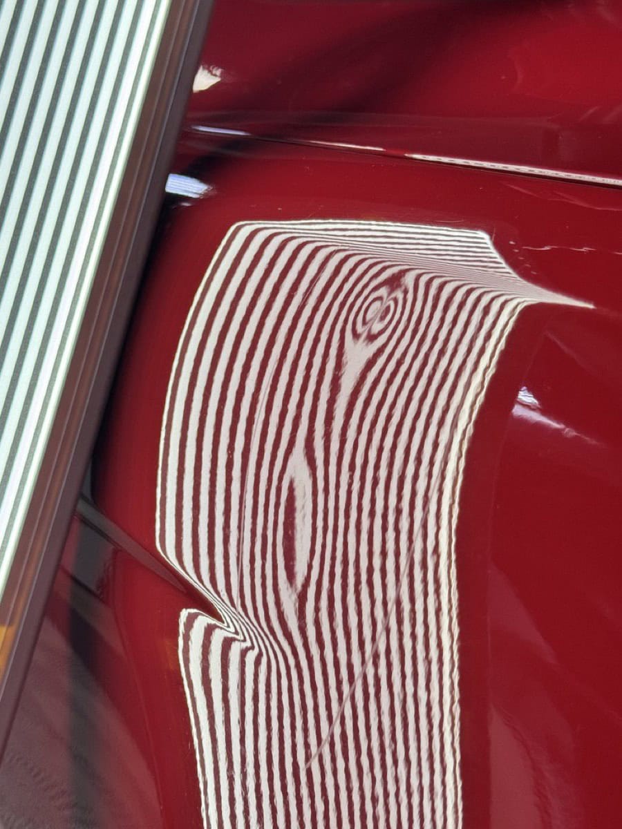 BMW M5 fender dent damage before repair