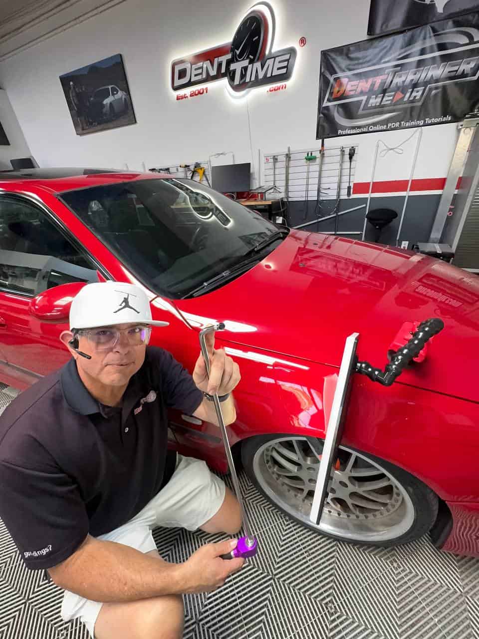 Myke Toledo performing PDR on BMW M5 fender at Dent Time San Diego